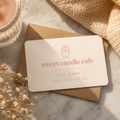 Gift card from Sweet Candle Cafe on a marble surface with a candle and flowers.